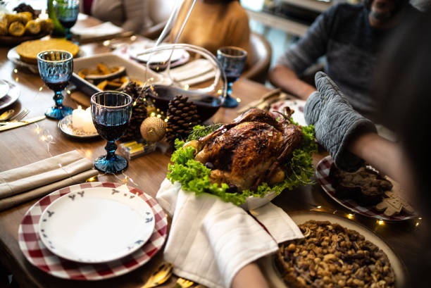 Hands serving a roast turkey on Christmas at home
