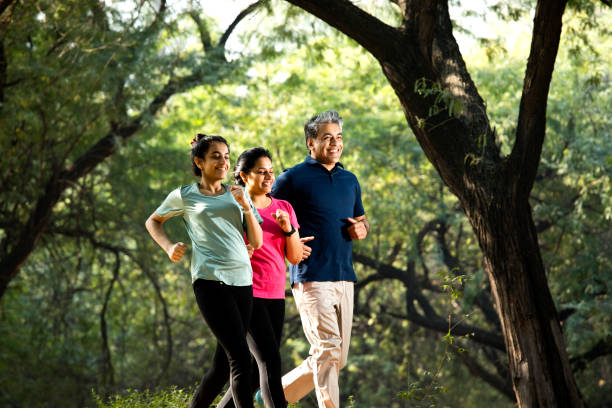 istock Happy family jogging at park 1357014386