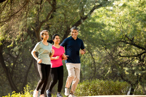 istock Happy family jogging at park 1357014408