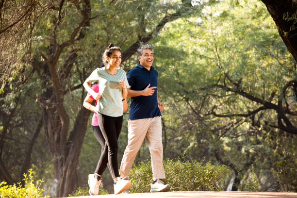 istock Happy family jogging at park 1357014416