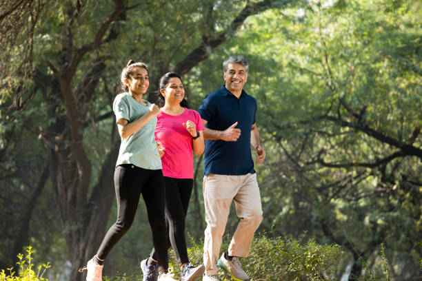 istock Happy family jogging at park 1357014431