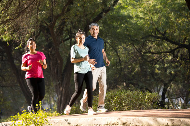 istock Happy family jogging at park 1357014488