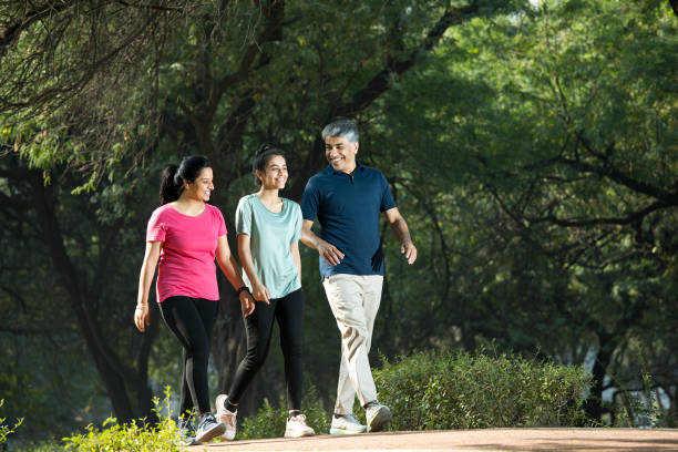 istock Happy family walking at park 1357014504