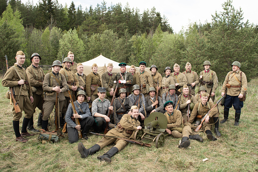 PETROZAVODSK, RUSSIA - MAY 22, 2021: Soldiers in military uniform of the second world war at the historical reconstruction 'First Battle of the 41st' fit into one shoot for photo