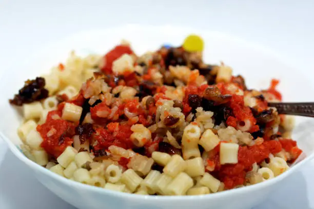 Photo of Egyptian cuisine, Koshary the national dish of Egypt and popular street food made of rice, macaroni, and lentils mixed together topped with a spiced tomato sauce