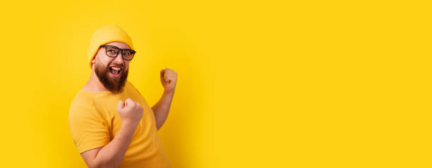 istock successful bearded man over yellow background, 1357016360