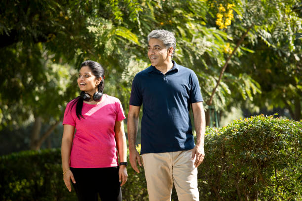 istock Happy couple admiring nature at park 1357016412