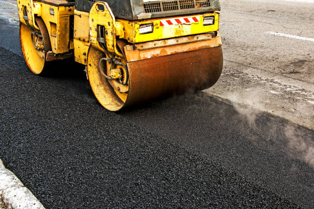 istock Compact steamroller flatten out the asphalt. Heavy Vibration roller at asphalt pavement works. 1357017043