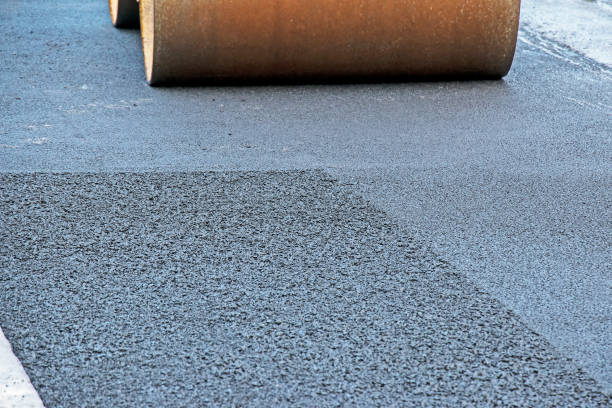 istock Compact steamroller flatten out the asphalt. Heavy Vibration roller at asphalt pavement works. 1357017052
