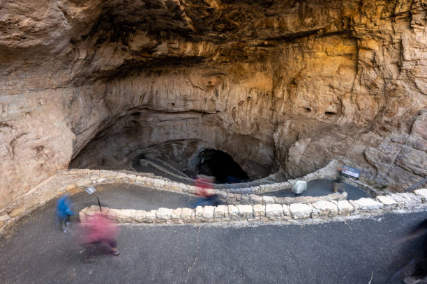 istock Blurred Hikers Walking into the Natural Entrance 1357017076