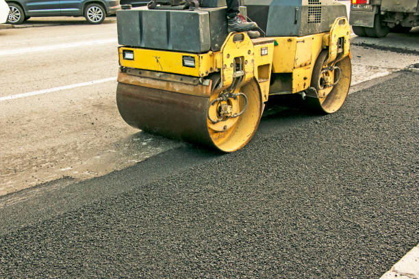 istock Compact steamroller flatten out the asphalt. Heavy Vibration roller at asphalt pavement works. 1357017095