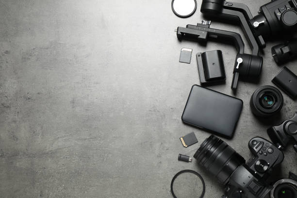istock Camera and video production equipment on grey stone background, flat lay. Space for text 1357018581
