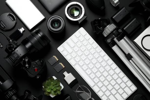 istock Flat lay composition with camera, video production equipment and computer keyboard on black background 1357019455