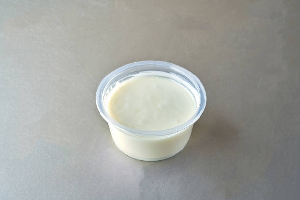 istock White Chocolate sauce in bowl  , isolated on gray background 1357019623