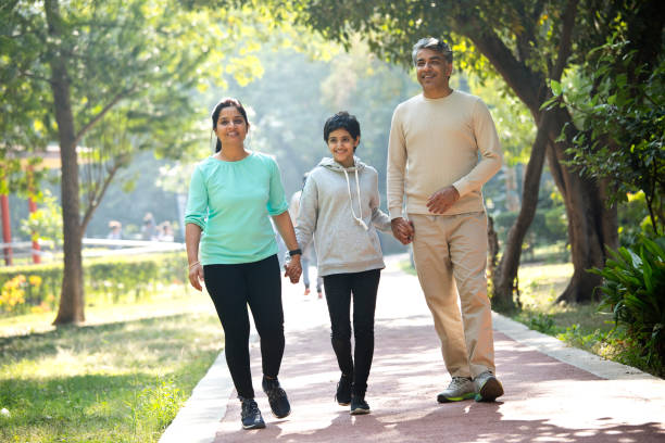 istock Happy family walking at park 1357020466