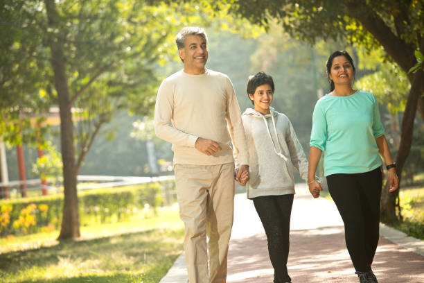 istock Happy family walking at park 1357020471