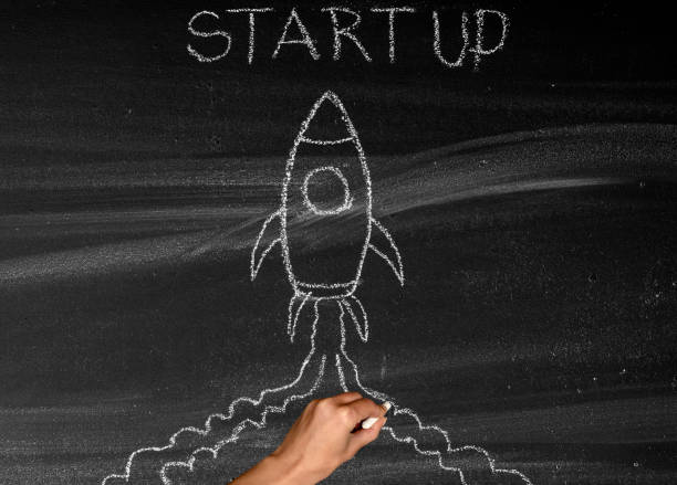 istock Business Startup Concept with Spaceship on chalkboard 1357020554