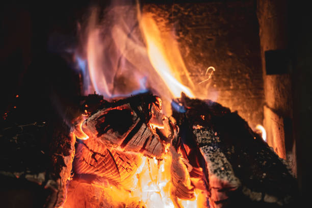 istock Fire burning glowing in rustic wood burning cast iron stove, log burner for heating or fireplace 1357021300