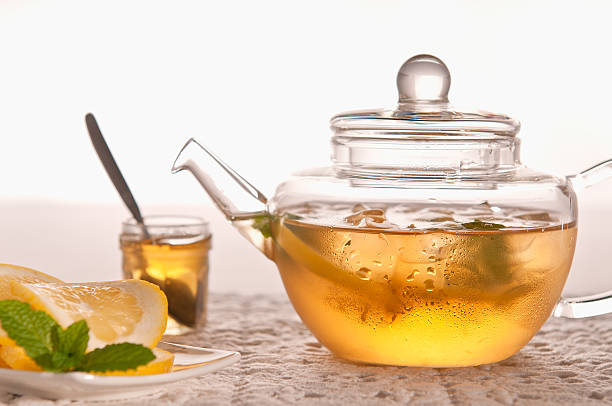 Ice Tea in Teapot With Honey, Lemon And Mint