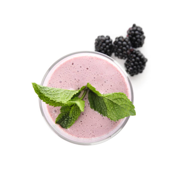 istock Tasty milk shake with blackberries and mint isolated on white 1357023273