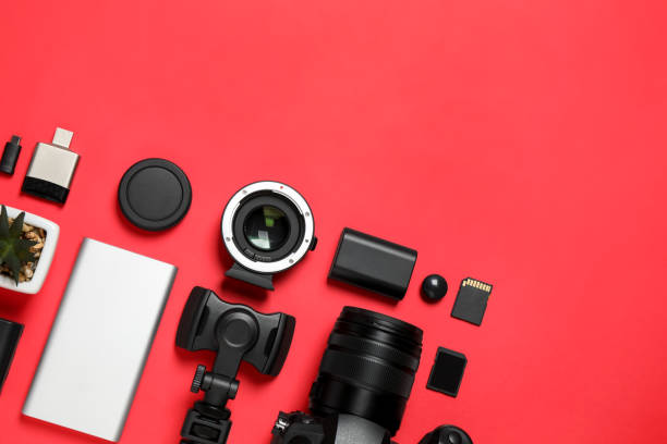 istock Flat lay composition with camera and video production equipment on red background. Space for text 1357024110