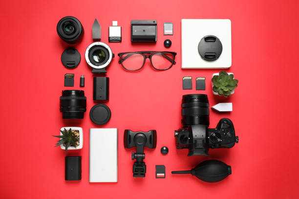 istock Flat lay composition with camera and video production equipment on red background. Space for text 1357024256