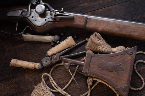 17th century ancient flintlock musket with powder flask and led bullets. - 17th century style imagens e fotografias de stock