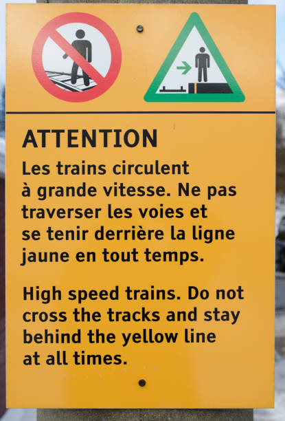 istock Bilingual warning sign at train station 1357026795