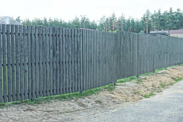 istock long wooden gray black fence wall 1357027606