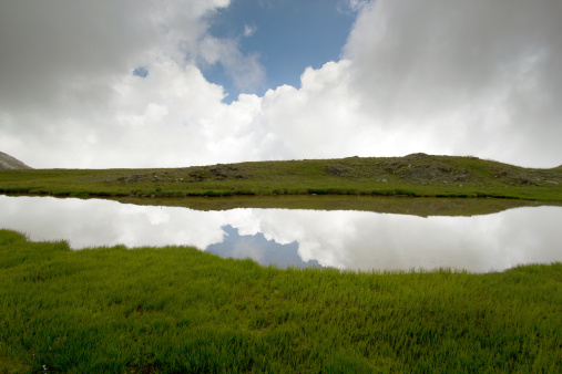 Mountan lake with nice reflection of clouds in water.   Picture was  taken from mountain called Golem Korab, 2764m which is the highest mountain in country Republica Macedonia.  Golem Korab is part of Sar Planina massif which is over 50km long.