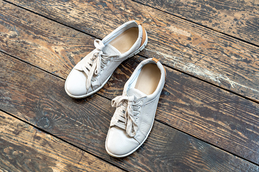 beige shoes on wooden background