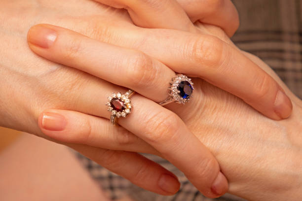 Diamond rings on female hands stock photo
