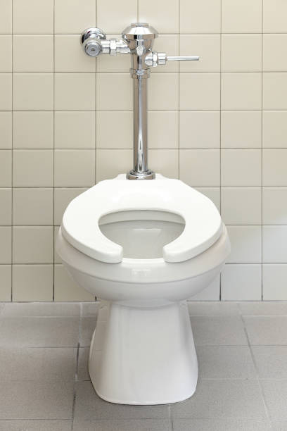 Public rest room handicapped stall toilet The high toilet in the handicapped stall in a public restroom. flushing valve public restroom toilet stock pictures, royalty-free photos & images