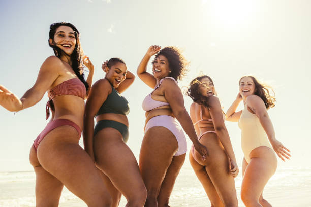 istock Group of young women dancing in bikinis 1357041963