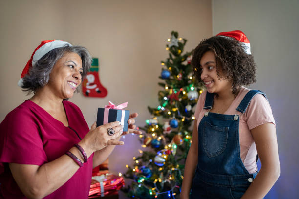 istock Mother giving Christmas present to her daughter 1357042736