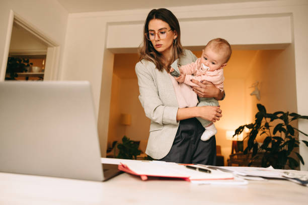 istock Professional interior designer holding her baby in her home office 1357043958