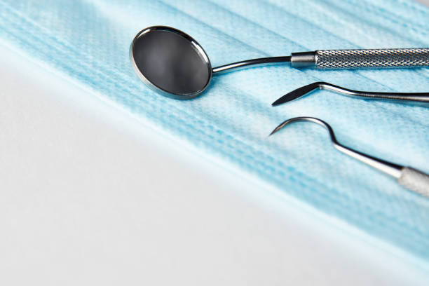 istock Dentist tools and medical mask on white background 1357044791