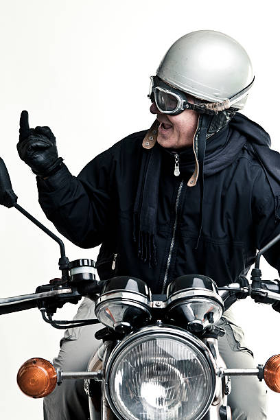 istock man drive his motorcycle with helmet and glasses 135704978