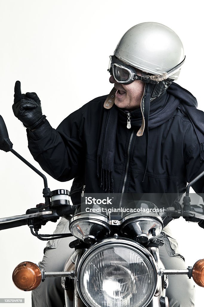 man drive his motorcycle with helmet and glasses man drive his motorcycle with helmet and glasses making the finger. Helmet Stock Photo