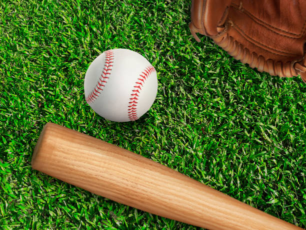 istock baseball, glove, ball and bat on field 1357049881