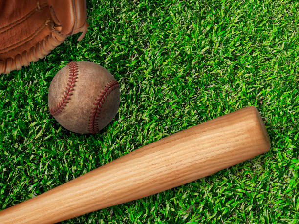 istock baseball, glove, ball and bat on field 1357049948
