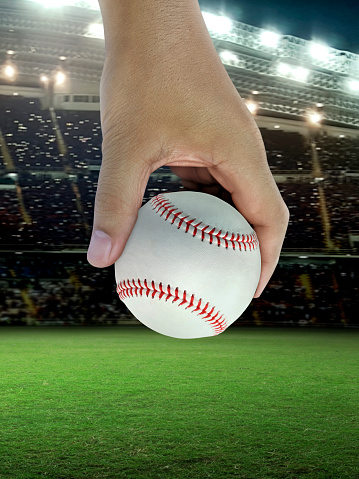 Baseball in hand, on professional baseball stadium
