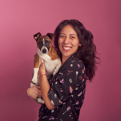 Latin Woman with dog smiling studio