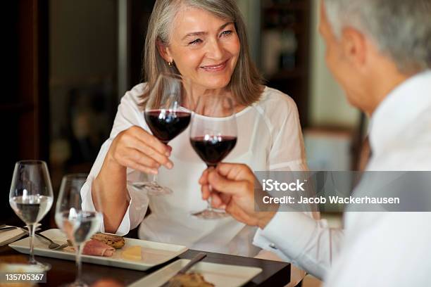 Toasting To Their Relationship Stock Photo - Download Image Now - Senior Adult, Restaurant, Gourmet