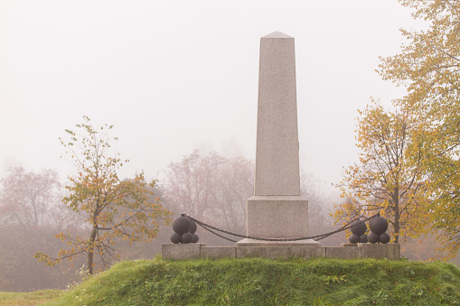 Stone monument in autumn foggy day in Vyborg, Russia