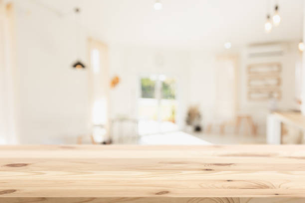 istock Empty wood table with blur coffee shop background clean bright light foreground Mock up for montage products display 1357063698