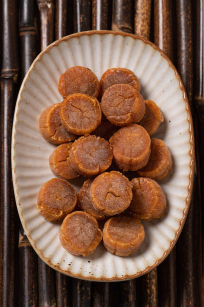 istock Dried scallop on wooden table. 1357064734