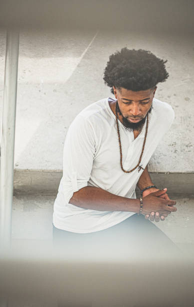 istock Young Black man relaxes on cement city staircase 1357065739