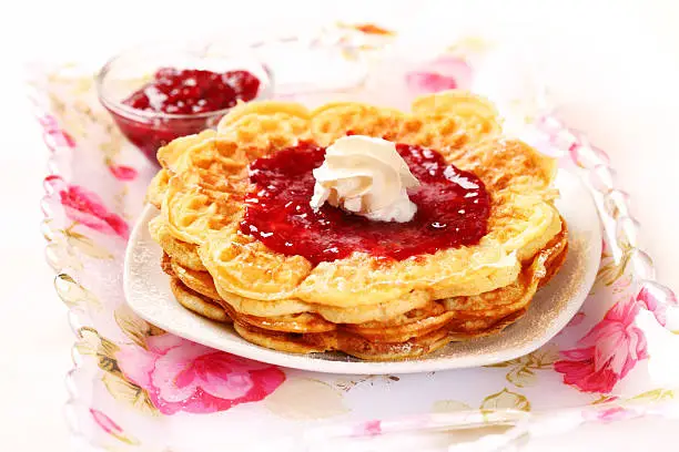 Waffles with fresh strawberry jam and whipped cream