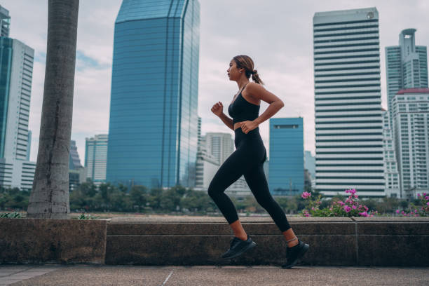 istock Woman jogging in a city park 1357068210